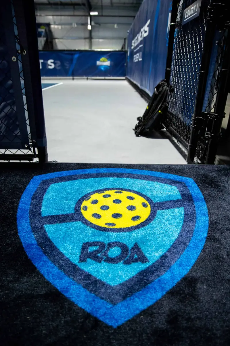 The ROA shield logo inlaid at the entrance to the courts